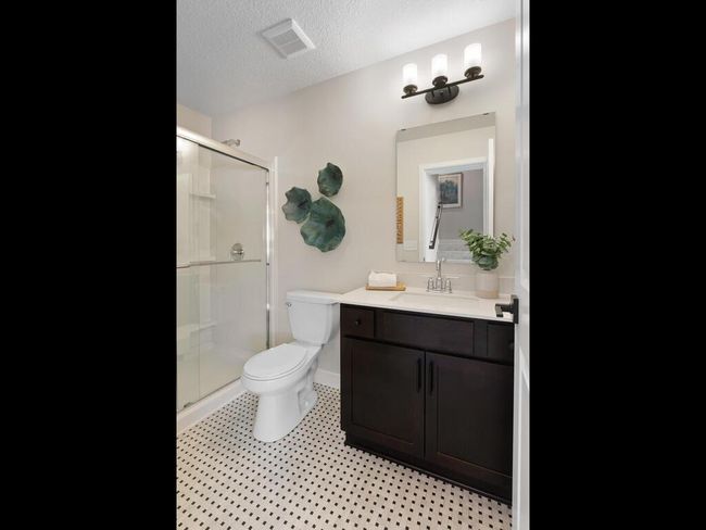 Bathroom 4 in the lower level features a stylish 5' walk-in shower, offering both convenience and comfort with modern finishes and a well-designed layout. | Image 43