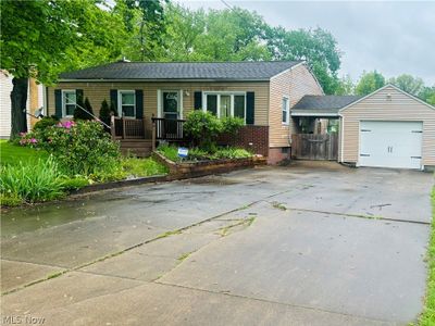 View of front of ranch-style home with a garage | Image 1