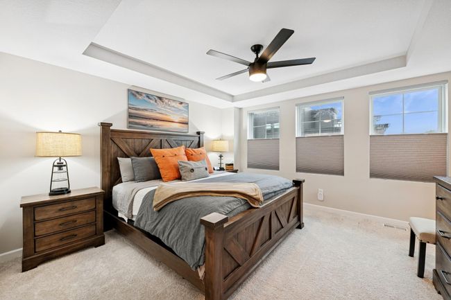 Spacious and filled with natural light, this serene primary bedroom features large windows that frame picturesque views of the beautiful River Walk Park. | Image 26