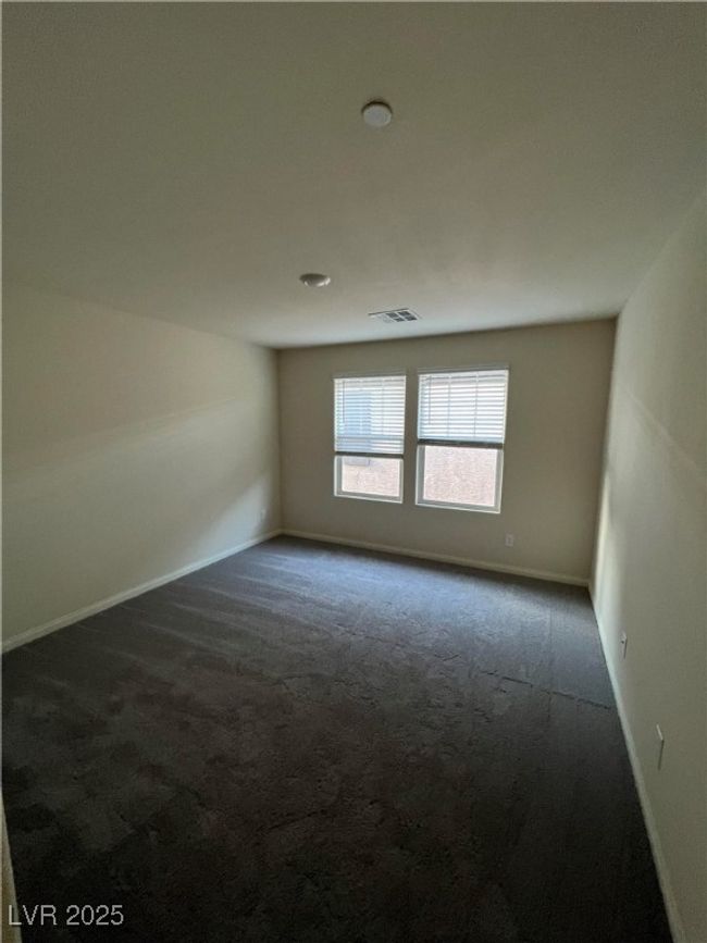Empty room featuring dark colored carpet and baseboards | Image 23