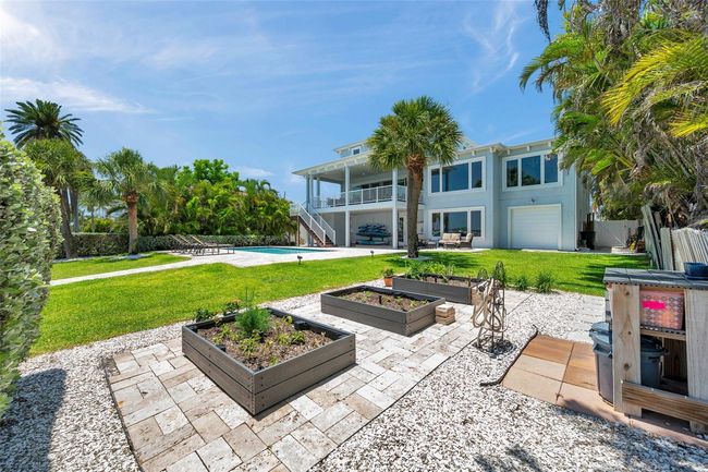 Three Trex garden boxes surrounded by travertine pavers (stay cooler!) that match the pool deck. | Image 95