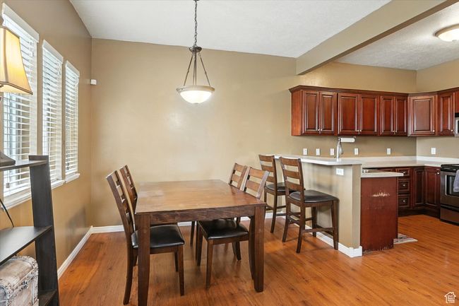 Dining space with light wood-type flooring and baseboards | Image 7