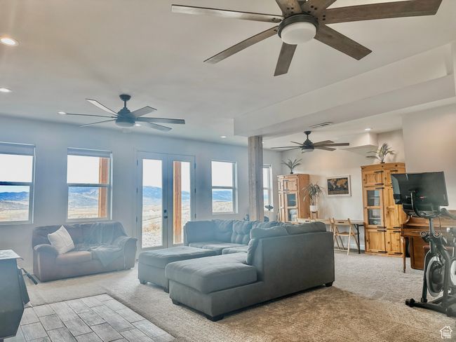 Living room featuring visible vents, ceiling fan, recessed lighting, light carpet, and french doors | Image 26