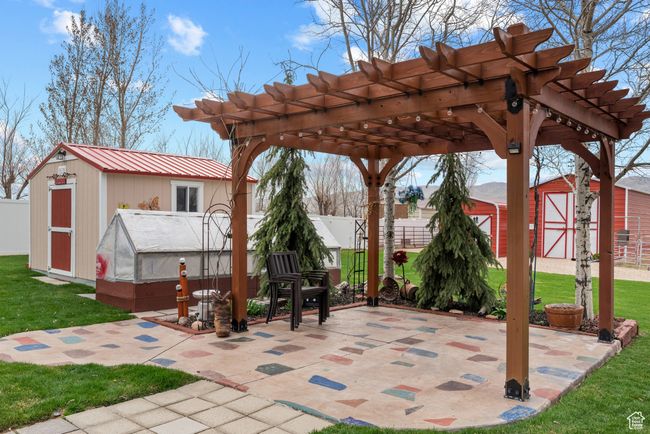 View of patio / terrace featuring an outdoor structure, a pergola, a shed, and fence | Image 31