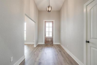 Entryway with a chandelier and light hardwood / wood-style flooring | Image 3