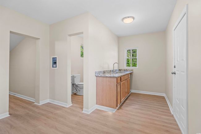 Bar area with light wood-style flooring | Image 32