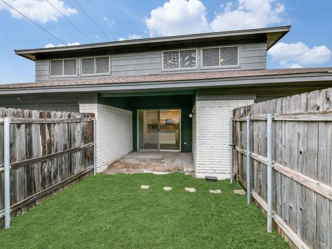 Back of house with brick siding and roof with shingles | Image 15
