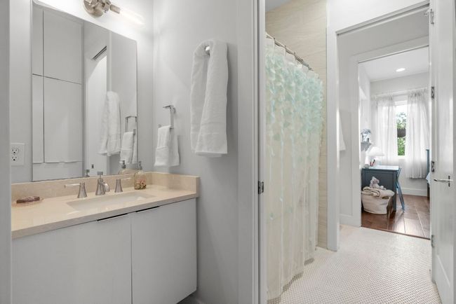 Jack & Jill floating vanities, quad pocket doors, and white penny tile. | Image 29
