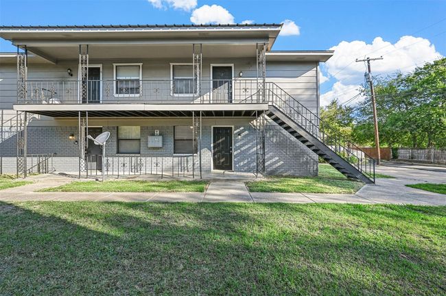 Multi unit property featuring stairway, covered porch, a balcony, and brick siding | Image 15