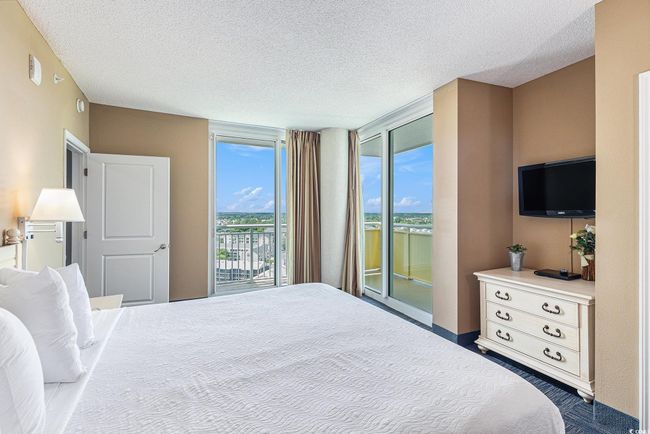 Bedroom with access to exterior and a textured ceiling | Image 16