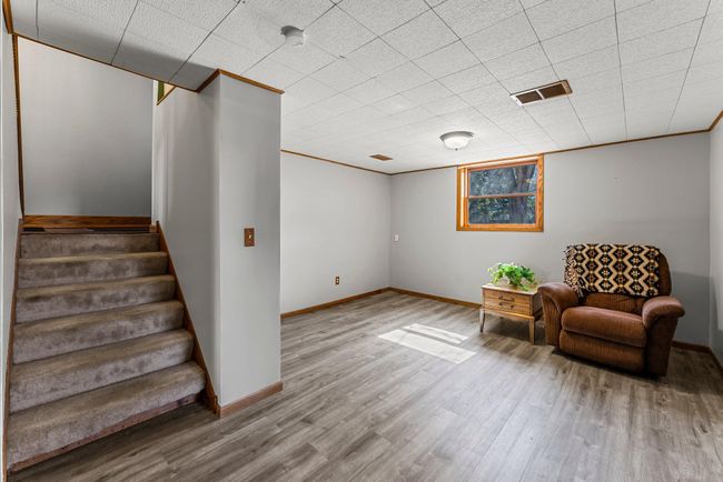 The lower level features the family room, an inviting space with LVP flooring and lookout windows—ideal for movie nights or relaxation. | Image 13