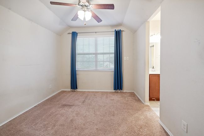 Unfurnished room with light carpet, vaulted ceiling, and a ceiling fan | Image 17