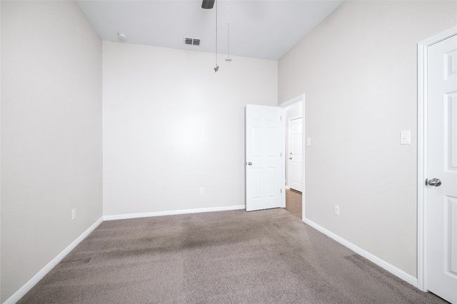 Carpeted empty room with ceiling fan and a smoke detector | Image 29