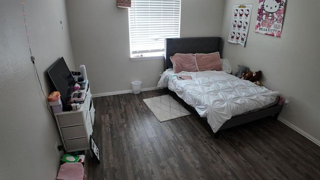 Bedroom with wood finished floors and baseboards | Image 9