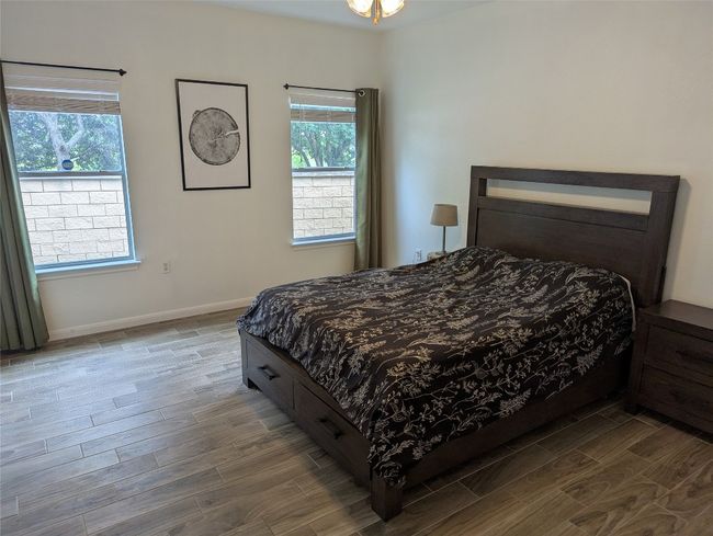 Bedroom with wood finished floors and baseboards | Image 10