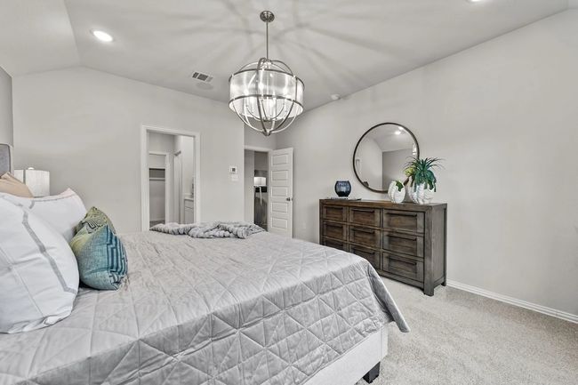Bedroom featuring light carpet, a chandelier, baseboards, recessed lighting, and vaulted ceiling | Image 12