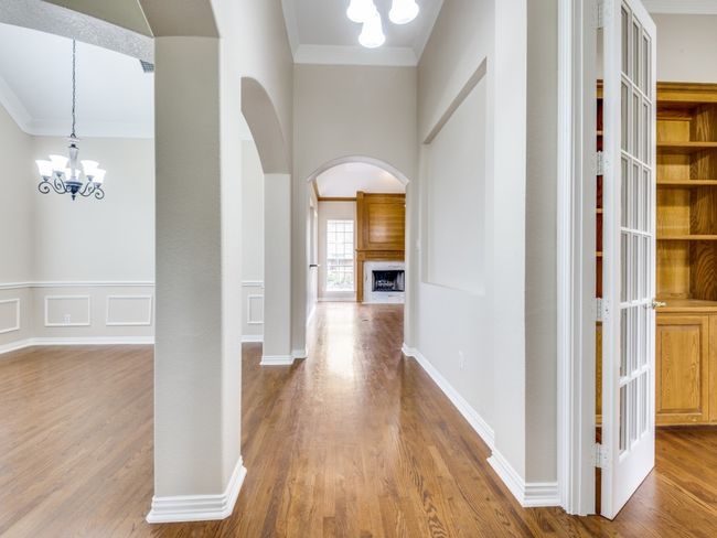 View from the moment you step into this lovely custom home with real hardwood floors, crown molding, decorative lighting and arched entry ways. | Image 5