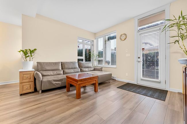 Living room with light wood-style flooring and baseboards | Image 5