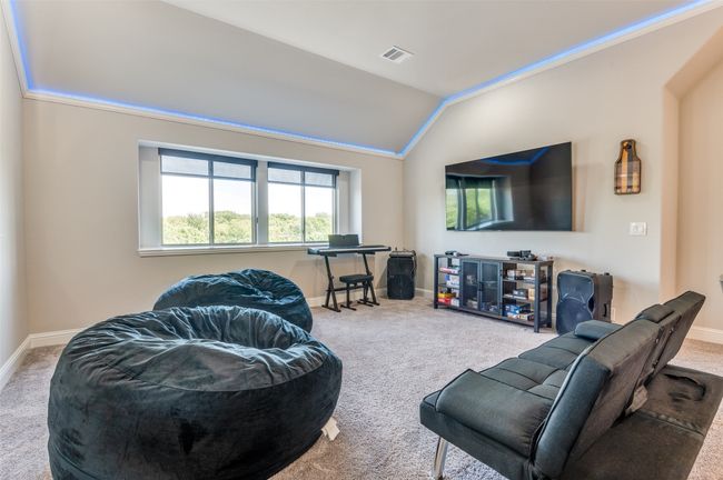 Carpeted living area featuring lofted ceiling and crown molding | Image 17