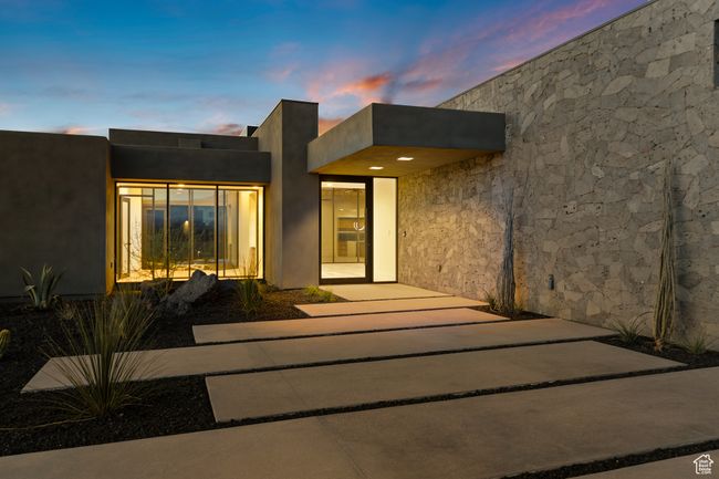 Exterior entry at dusk with stucco siding | Image 10