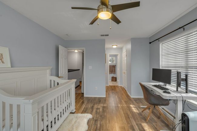Bedroom featuring wood-type flooring, a desk, and ceiling fan | Image 24