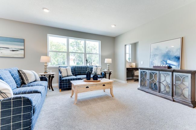 Soaring windows flood your main level family room in natural light - overlooking a sodded generous size backyard & enlightening a space large enough to accommodate just about any furniture combination! Photo of model home, color & options will vary. | Image 9