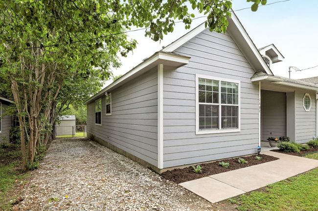 View of property exterior featuring a gate and fence | Image 36