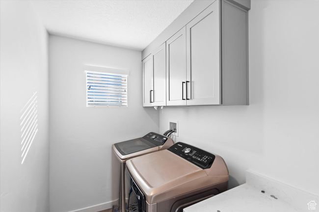 Laundry area featuring cabinet space and washer and dryer | Image 19