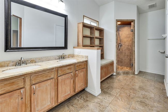 Full bathroom with a shower stall and double vanity | Image 13