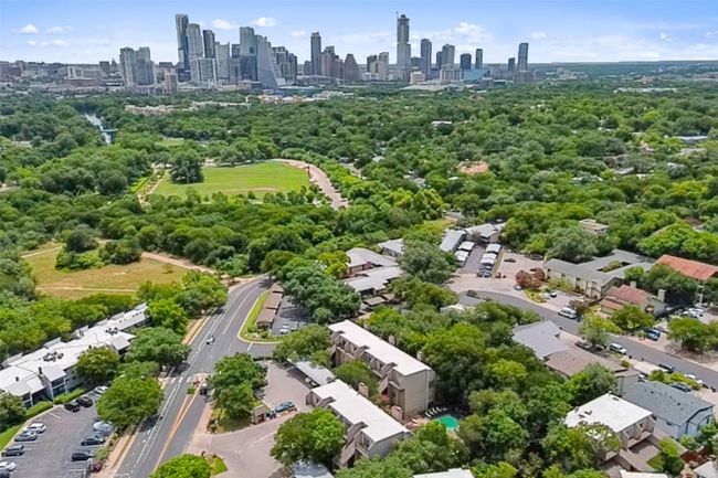 Drone / aerial view of city skyline and a tree filled landscape | Image 24