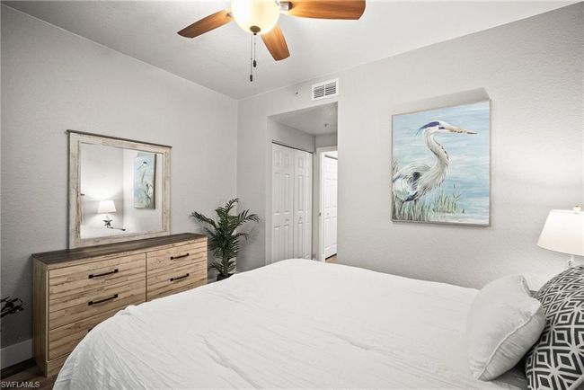 Bedroom with a closet, ceiling fan, and visible vents | Image 14