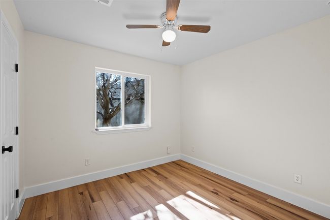 Unfurnished room with baseboards, light wood finished floors, and a ceiling fan | Image 18