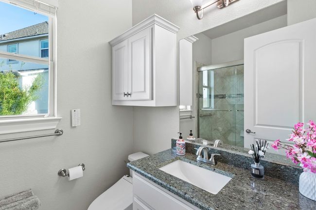 Full bath featuring a shower stall, vanity, and toilet | Image 31