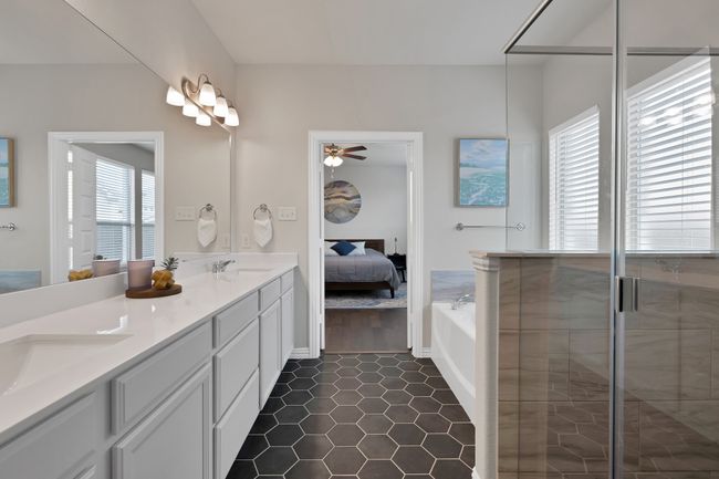 Bathroom with a sink, a shower stall, ensuite bathroom, and ceiling fan | Image 22