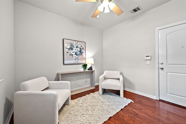 First floor sitting area, office, workout room, kids playroom. Door goes to attached two story garage. | Image 5