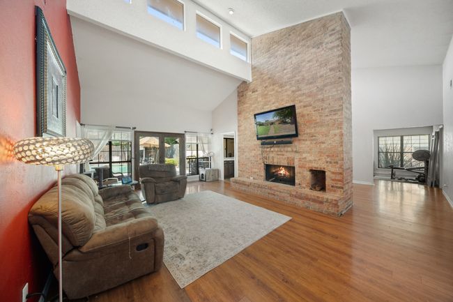 Living room looks out onto the covered patio and pool | Image 8