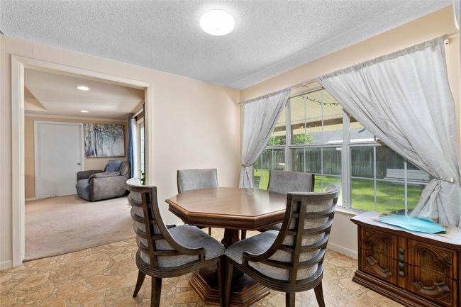 Second dining area is the Eat-In kitchen area with large window showcasing the beautiful backyard and access to second living area designated as the den. Opposite direction takes you to the utility room and back door to backyard, not pictured. | Image 18