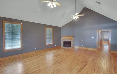 Living room with high ceilings & wood burning fireplace | Image 3