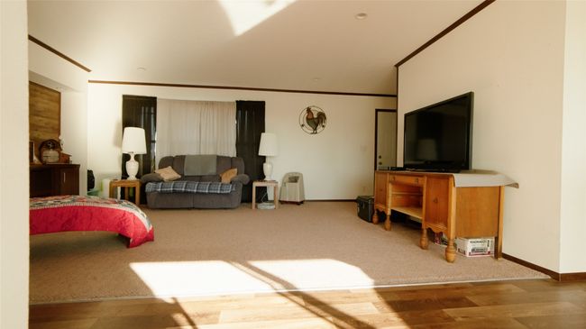 Living room featuring carpet flooring, wood finished floors, baseboards, and ornamental molding | Image 15
