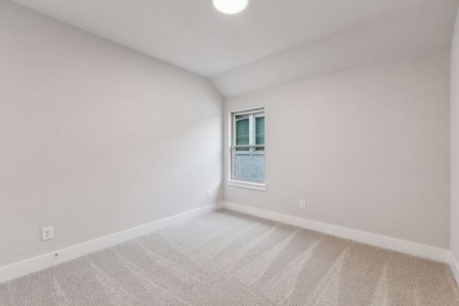 Unfurnished room featuring light colored carpet and vaulted ceiling | Image 29