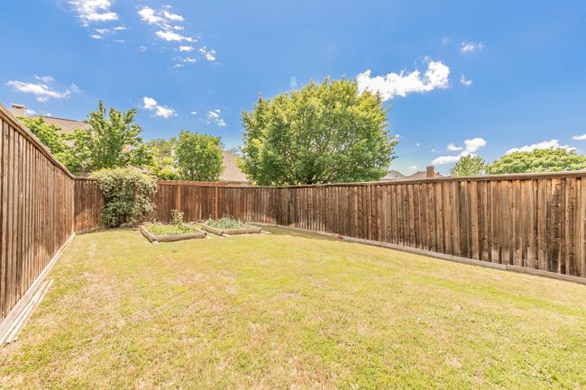 View of yard with a fenced backyard and a vegetable garden | Image 37
