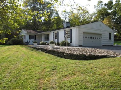 Ranch-style home featuring a garage and a front lawn | Image 2