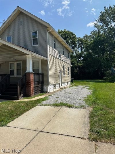 View of side of property with a lawn and covered porch | Image 2