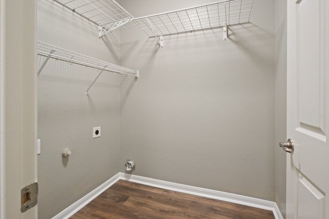 Laundry room with electric dryer hookup, baseboards, and dark wood-style flooring | Image 15