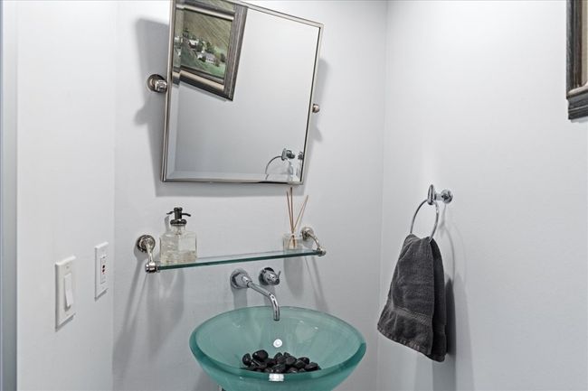 Bathroom off the hallway with a sink | Image 17