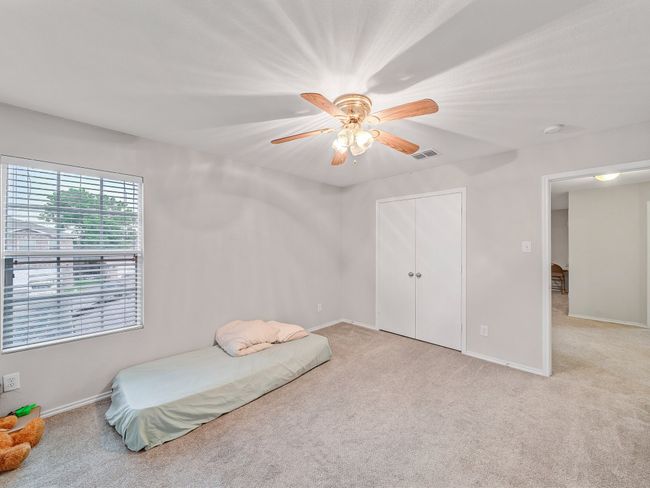 Bedroom featuring light carpet, baseboards, and ceiling fan | Image 28