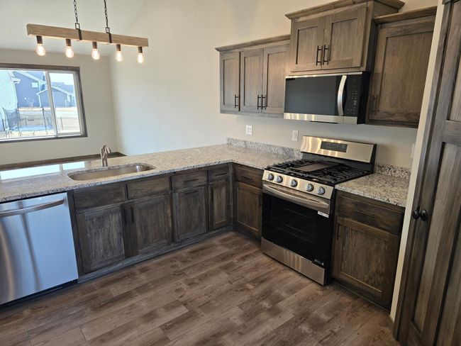 Lots of custom built popal cabinetry and desirable luxurious vinyl plank flooring. | Image 4