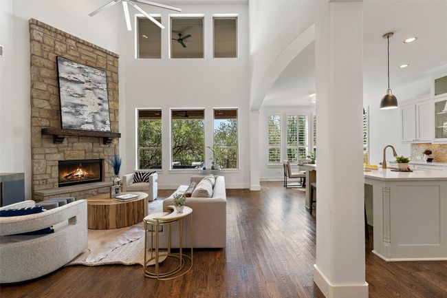 Living room with a ceiling fan, a fireplace, dark wood finished floors, arched walkways, and recessed lighting | Image 14
