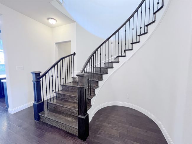 Stairway with wood finished floors and baseboards | Image 25