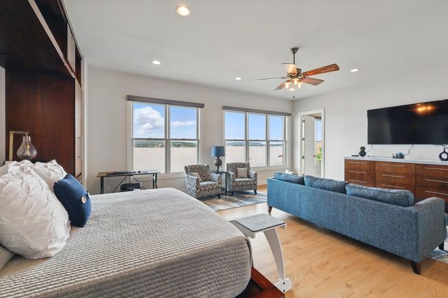 Bedroom with light wood-type flooring, recessed lighting, and ceiling fan | Image 33
